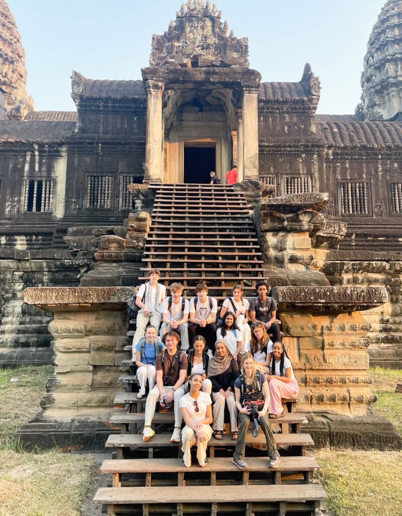 group sitting in front of ruins