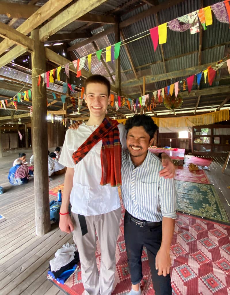 people laughing in building decorated with color flags