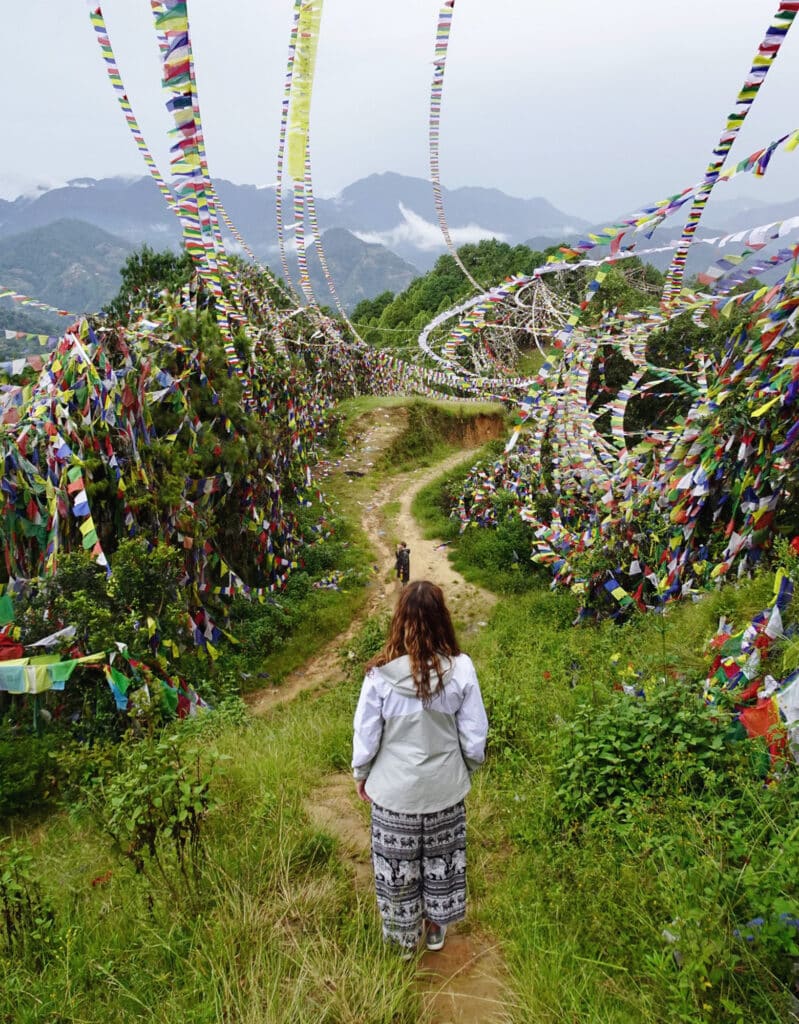 girl walking through field of prayer flags